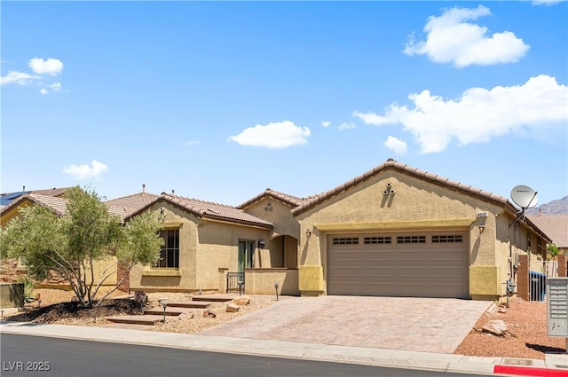 4212 Helens Pouroff Ave, North Las Vegas, NV 89085 - mediterranean / spanish home featuring an attached garage, stucco siding, decorative driveway, and a tiled roof