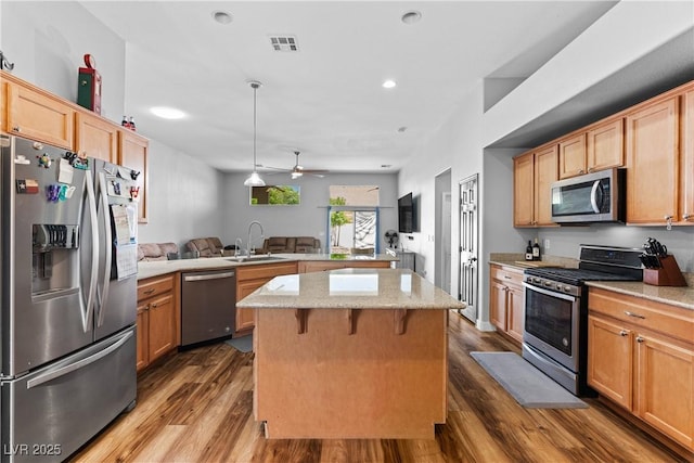 4212 Helens Pouroff Ave, North Las Vegas, NV 89085 - kitchen with appliances with stainless steel finishes, a peninsula, a ceiling fan, dark wood-type flooring, and open floor plan