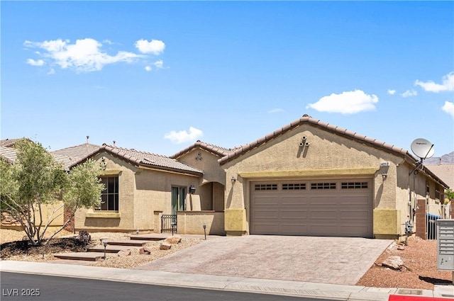 4212 Helens Pouroff Ave, North Las Vegas, NV 89085 - view of front of house featuring an attached garage, stucco siding, decorative driveway, and a tiled roof