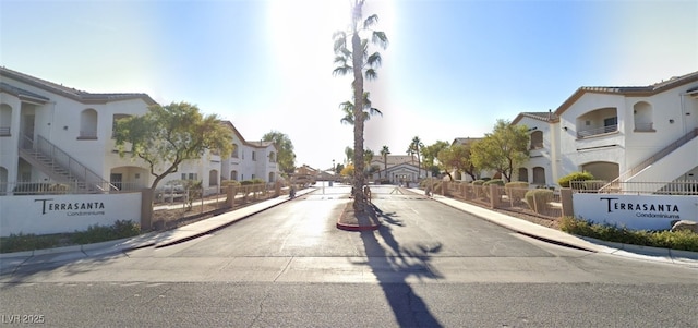 5655 E Sahara Ave Unit 1053, Las Vegas, NV 89142 - view of asphalt street featuring a residential view, curbs, a gated entry, and sidewalks