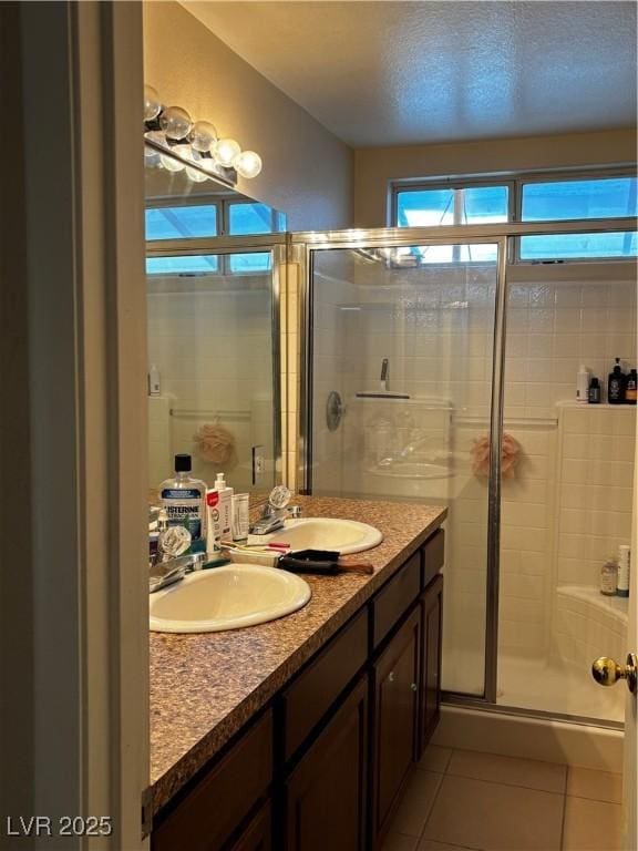 3601 Slapton Ave, North Las Vegas, NV 89031 - bathroom featuring tile patterned flooring, a shower stall, and double vanity