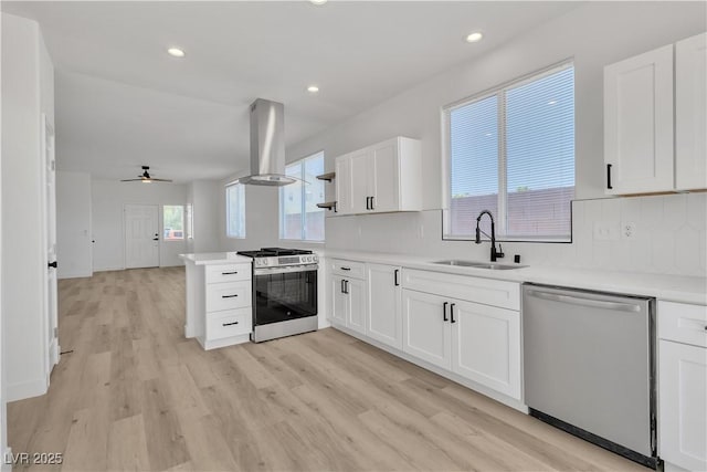 8944 W Rochelle Ave, Las Vegas, NV 89147 - kitchen with stainless steel appliances, island exhaust hood, white cabinetry, light countertops, and backsplash