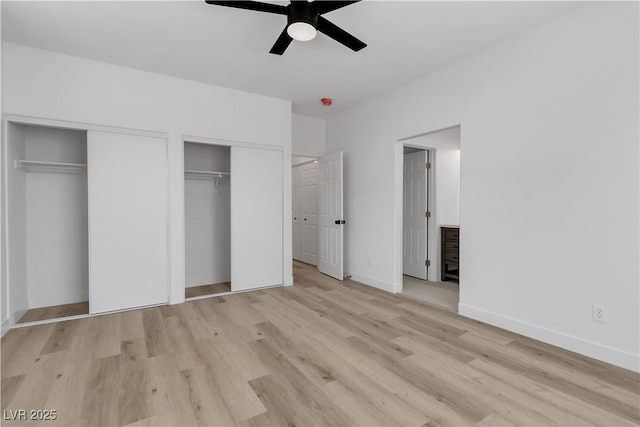 8944 W Rochelle Ave, Las Vegas, NV 89147 - unfurnished bedroom featuring two closets, wood finished floors, and a ceiling fan