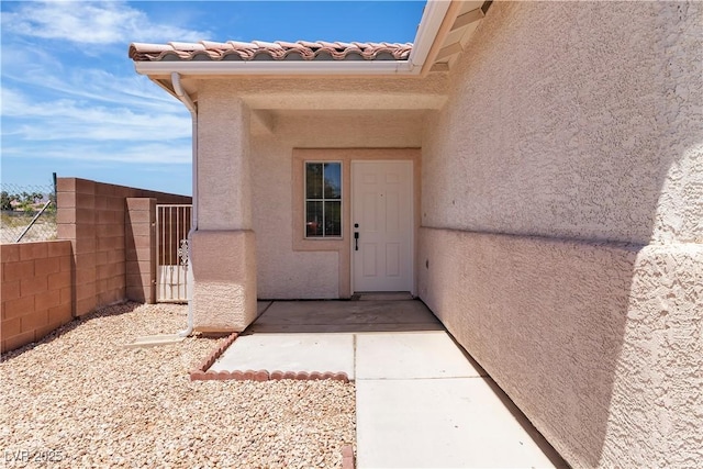 8944 W Rochelle Ave, Las Vegas, NV 89147 - view of exterior entry featuring stucco siding and a gate