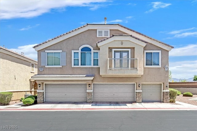 6559 Tumbleweed Ridge Ln Unit 103, Henderson, NV 89011 - multi unit property with stucco siding, an attached garage, stone siding, and a balcony