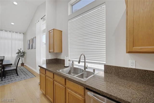 5512 Goldbrush St, Las Vegas, NV 89130 - kitchen featuring light wood-style floors, dishwasher, recessed lighting, dark stone countertops, and high vaulted ceiling