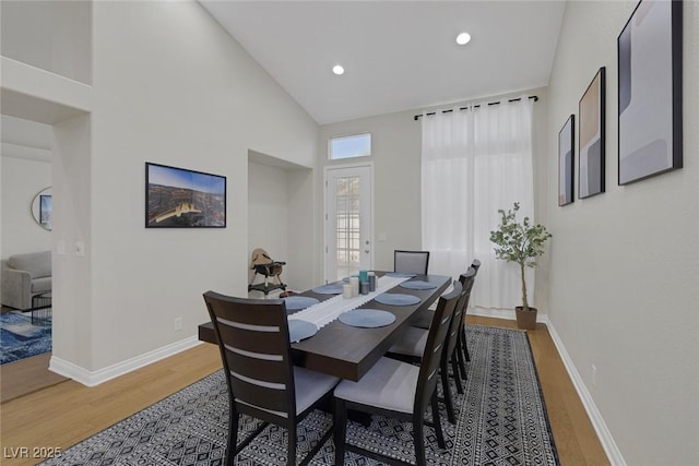 5512 Goldbrush St, Las Vegas, NV 89130 - dining area featuring light wood finished floors, high vaulted ceiling, and recessed lighting