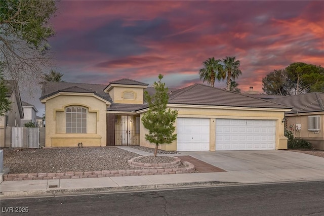5512 Goldbrush St, Las Vegas, NV 89130 - view of front of property featuring a tiled roof, driveway, a garage, and stucco siding