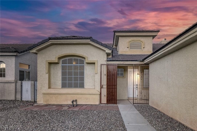 5512 Goldbrush St, Las Vegas, NV 89130 - property entrance with stucco siding, a tile roof, and a gate