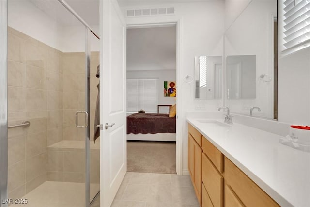 2261 Cold Canyon Ave, North Las Vegas, NV 89086 - full bathroom featuring vanity, connected bathroom, a stall shower, and tile patterned flooring