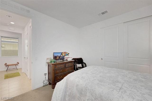 2261 Cold Canyon Ave, North Las Vegas, NV 89086 - bedroom with light carpet, a closet, and light tile patterned flooring