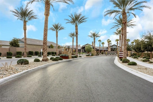 2261 Cold Canyon Ave, North Las Vegas, NV 89086 - view of asphalt road featuring curbs, a residential view, a gated entry, and sidewalks