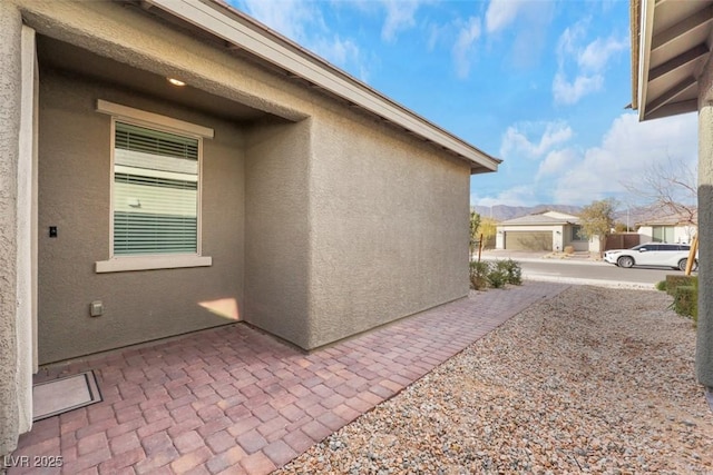 2261 Cold Canyon Ave, North Las Vegas, NV 89086 - view of side of property featuring stucco siding and a patio area