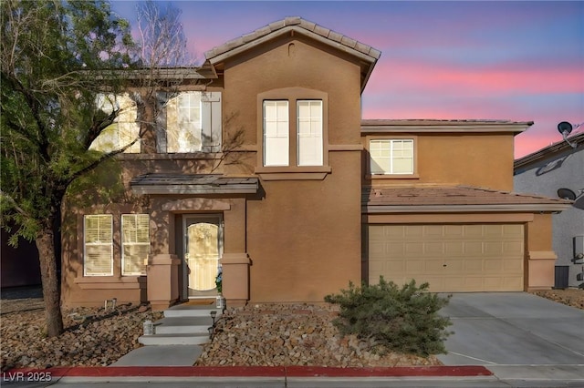 5308 Carlsbad Heights St, North Las Vegas, NV 89081 - view of front of home with driveway, stucco siding, and an attached garage