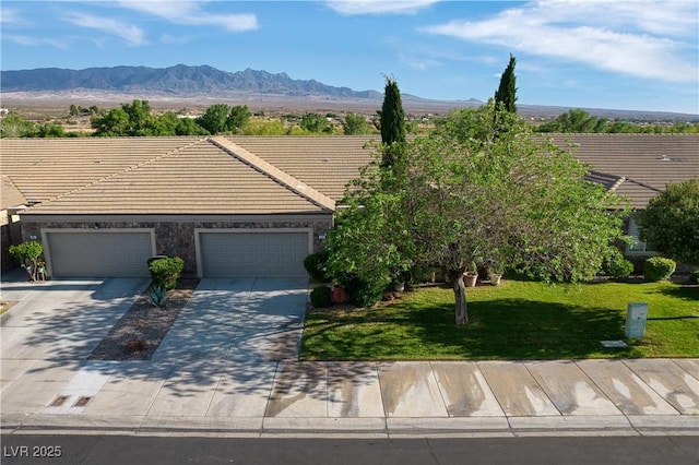693 Hagens Aly, Mesquite, NV 89027 - view of front of house featuring a tiled roof, a front lawn, concrete driveway, and a mountain view