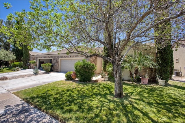 693 Hagens Aly, Mesquite, NV 89027 - view of front of house featuring a garage, driveway, a front lawn, and stone siding