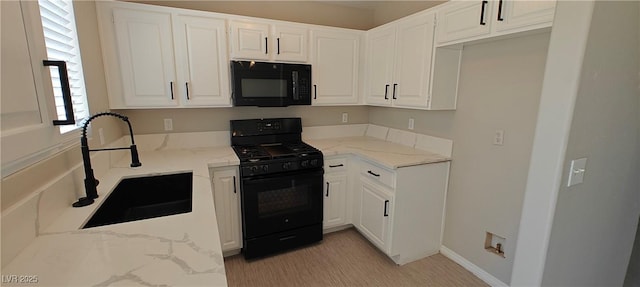 6615 Elk Creek Ln, Las Vegas, NV 89156 - kitchen with black appliances, light stone counters, and white cabinetry