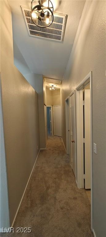 6615 Elk Creek Ln, Las Vegas, NV 89156 - hallway with carpet, attic access, and a chandelier