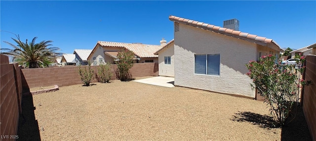 6615 Elk Creek Ln, Las Vegas, NV 89156 - back of property with a tiled roof, a fenced backyard, and stucco siding