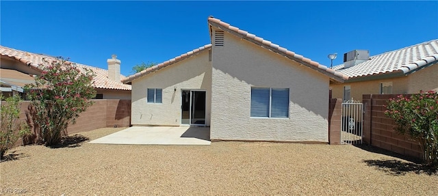 6615 Elk Creek Ln, Las Vegas, NV 89156 - back of property with a fenced backyard, a tile roof, stucco siding, and a patio