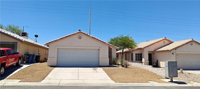 6615 Elk Creek Ln, Las Vegas, NV 89156 - ranch-style home with stucco siding, a tile roof, and a detached garage