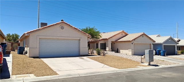 6615 Elk Creek Ln, Las Vegas, NV 89156 - view of front of house with a tiled roof, stucco siding, and a detached garage