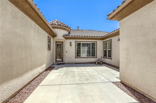 7286 Mount Kearsarge St, Las Vegas, NV 89131 - property entrance featuring stucco siding, a patio, and a tile roof