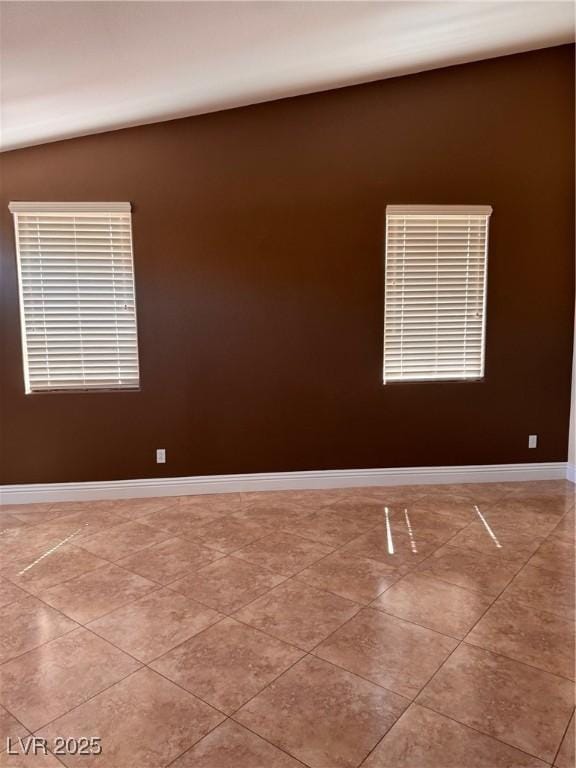5005 Wild Thyme Ave, Las Vegas, NV 89131 - tiled spare room featuring baseboards and vaulted ceiling