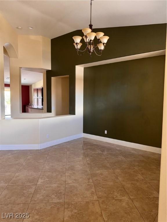 5005 Wild Thyme Ave, Las Vegas, NV 89131 - tiled spare room with a chandelier, arched walkways, and a towering ceiling