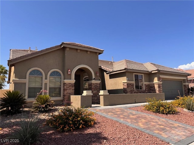 5005 Wild Thyme Ave, Las Vegas, NV 89131 - view of front of home featuring stone siding, stucco siding, an attached garage, and a tile roof