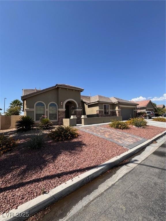 5005 Wild Thyme Ave, Las Vegas, NV 89131 - mediterranean / spanish home featuring stucco siding, a garage, and concrete driveway