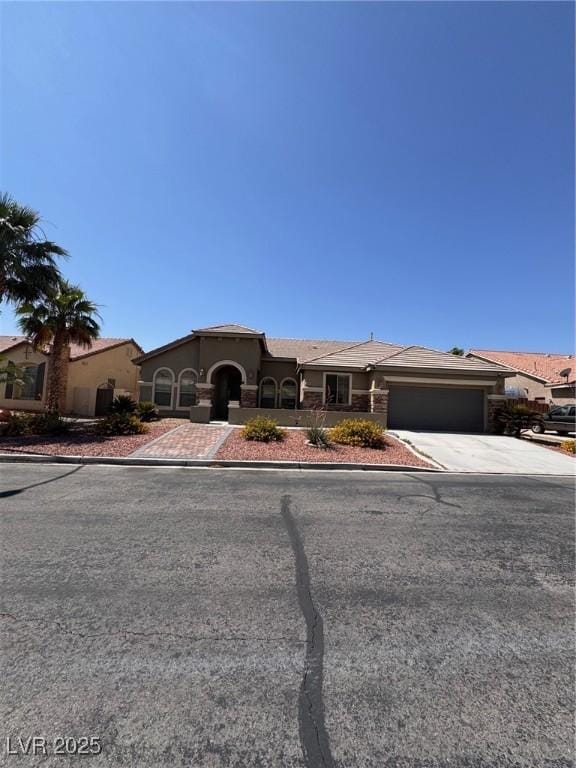 5005 Wild Thyme Ave, Las Vegas, NV 89131 - view of front facade with an attached garage, concrete driveway, and stucco siding