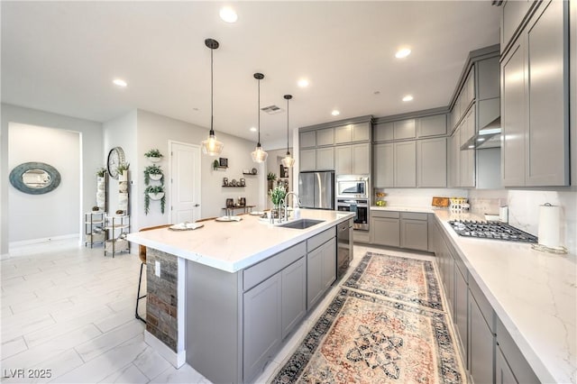 879 Klamath Springs St, Henderson, NV 89011 - kitchen featuring gray cabinets, appliances with stainless steel finishes, a breakfast bar, light stone counters, and recessed lighting