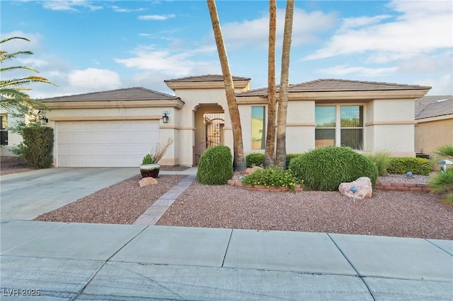 585 Mountain Links Dr, Henderson, NV 89012 - prairie-style home featuring concrete driveway, an attached garage, stucco siding, and a tile roof