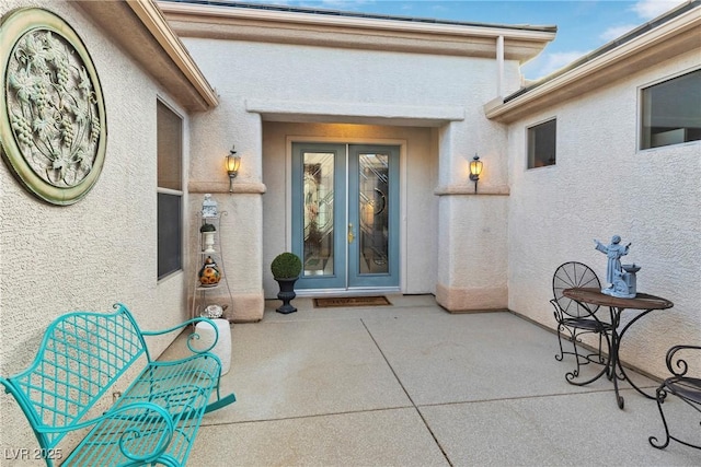 585 Mountain Links Dr, Henderson, NV 89012 - view of exterior entry with french doors, stucco siding, and a patio area