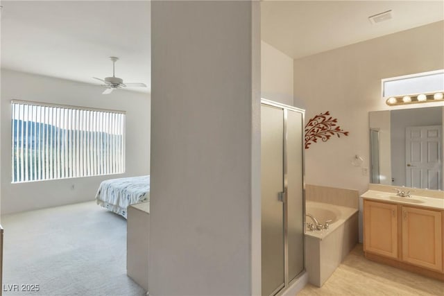 585 Mountain Links Dr, Henderson, NV 89012 - bathroom with a shower stall, a garden tub, vanity, ceiling fan, and ensuite bath