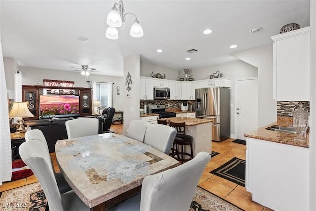 10918 Avenzano St, Las Vegas, NV 89141 - dining space featuring light tile patterned floors, a ceiling fan, recessed lighting, and a chandelier
