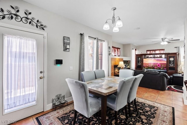 10918 Avenzano St, Las Vegas, NV 89141 - dining space featuring a chandelier, light tile patterned floors, and a ceiling fan