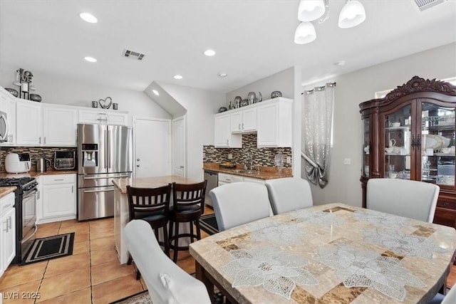 10918 Avenzano St, Las Vegas, NV 89141 - dining area featuring recessed lighting, light tile patterned flooring, and a chandelier