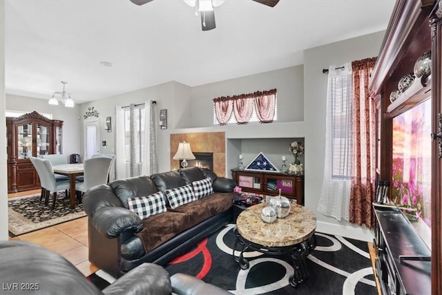 10918 Avenzano St, Las Vegas, NV 89141 - living area with light tile patterned flooring, ceiling fan, a tiled fireplace, and a chandelier