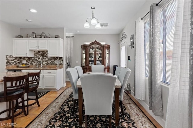 10918 Avenzano St, Las Vegas, NV 89141 - dining space featuring healthy amount of natural light, light tile patterned flooring, a chandelier, and recessed lighting