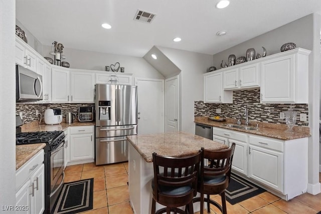10918 Avenzano St, Las Vegas, NV 89141 - kitchen with stainless steel appliances, white cabinetry, tasteful backsplash, light tile patterned floors, and recessed lighting