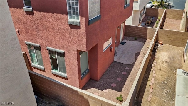 10918 Avenzano St, Las Vegas, NV 89141 - view of side of property with stucco siding, a fenced backyard, and a patio