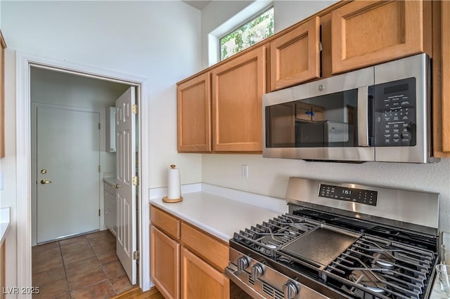 2413 Rockford St, Las Vegas, NV 89134 - kitchen with stainless steel appliances, light countertops, and brown cabinetry