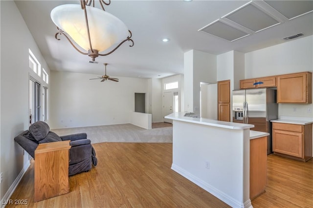 2413 Rockford St, Las Vegas, NV 89134 - kitchen featuring stainless steel refrigerator with ice dispenser, light wood-style floors, light countertops, recessed lighting, and open floor plan