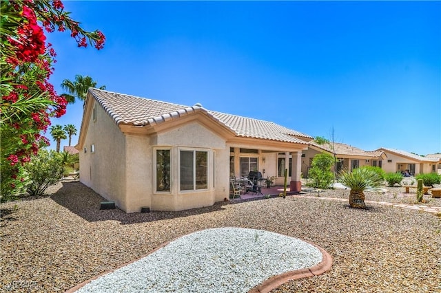 2413 Rockford St, Las Vegas, NV 89134 - back of property featuring stucco siding, a tile roof, and a patio area