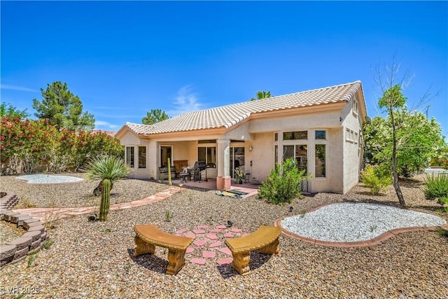 2413 Rockford St, Las Vegas, NV 89134 - rear view of house with a tile roof, stucco siding, and a patio