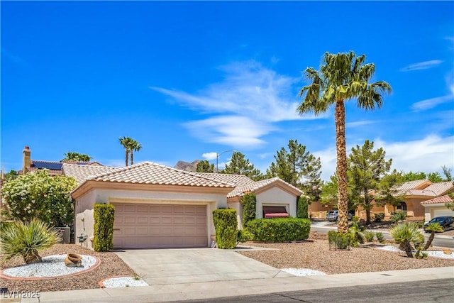 2413 Rockford St, Las Vegas, NV 89134 - mediterranean / spanish home featuring a tile roof, stucco siding, an attached garage, and concrete driveway