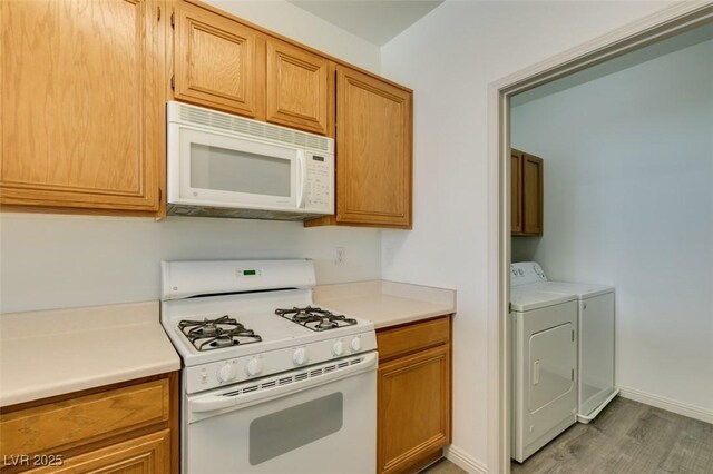 7163 S Durango Dr Unit 302, Las Vegas, NV 89113 - kitchen with white appliances, washer and clothes dryer, light wood finished floors, light countertops, and brown cabinetry