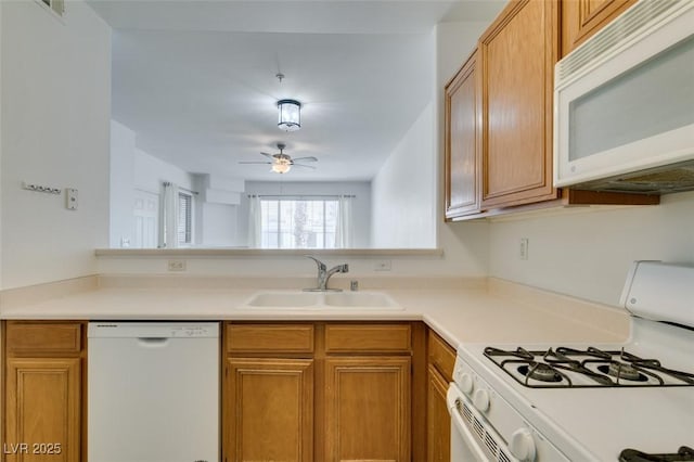 7163 S Durango Dr Unit 302, Las Vegas, NV 89113 - kitchen featuring white appliances, light countertops, ceiling fan, and brown cabinets